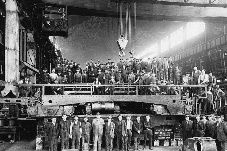 18th Century factory workers with a large engine
